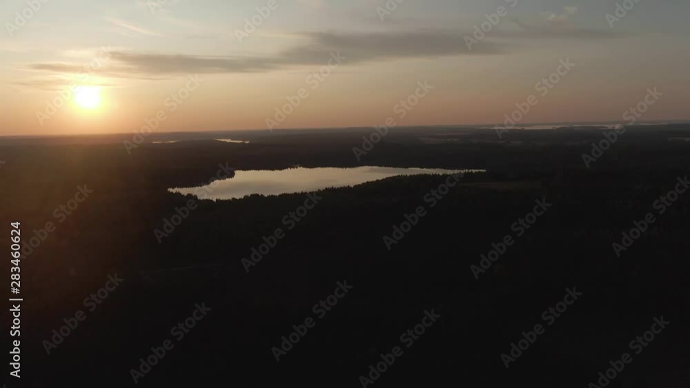 Sunset view. Drone shot of landscape with lake. Golden sky and horizon. Reflection in the water. Nature. Dark. Sunset view. Drone shot of landscape with lake. Golden sky and horizon. Reflection in the water. Nature. Dark.