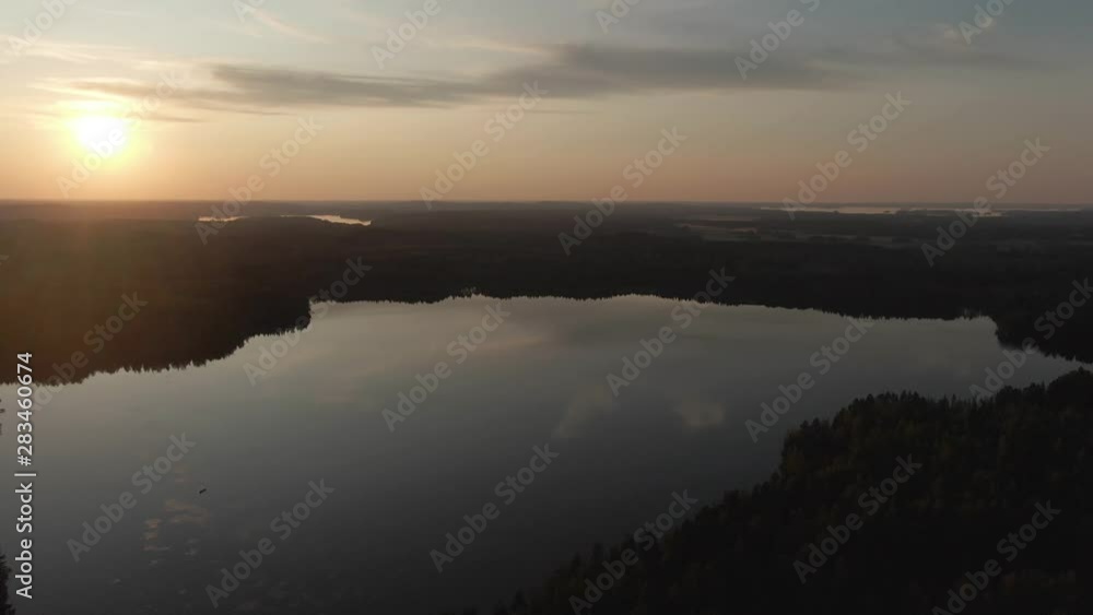 Sunset view. Drone shot of landscape with lake. Golden sky and horizon. Reflection in the water. Nature. Dark. Sunset view. Drone shot of landscape with lake. Golden sky and horizon. Reflection in the water. Nature. Dark.