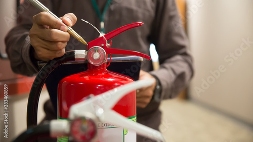 Fire extinguishers, Engineers are checking fire extinguishers. photo