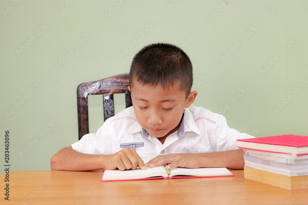Children go back to school. Little thinking boy doing homework at home. Children go back to school. Little thinking boy doing homework at home.