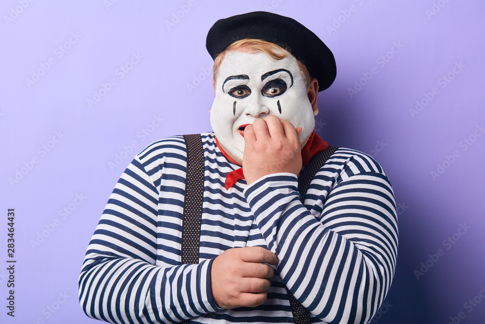 Terrified fat mime artist being afraid of children. facial expression. emotion and feeling, fear and comedy concept