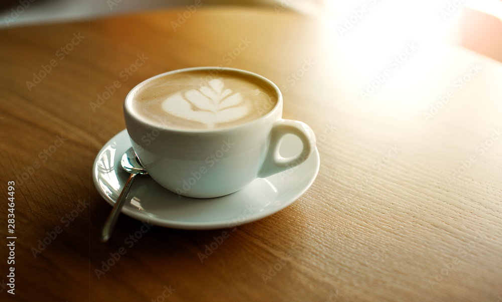 Cup of hot cappucino on the wooden table. Early morning breakfast Cup of hot cappucino on the wooden table. Early morning breakfast