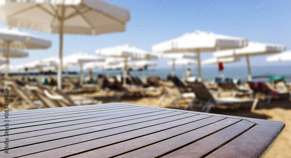 Table background and beach on sunny day in distance. Empty space for products and decoration. Table background and beach on sunny day in distance. Empty space for products and decoration.