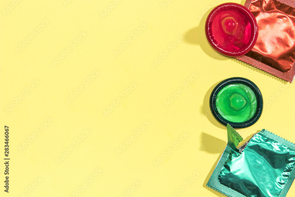 Flat lay colourful condoms with copy-space