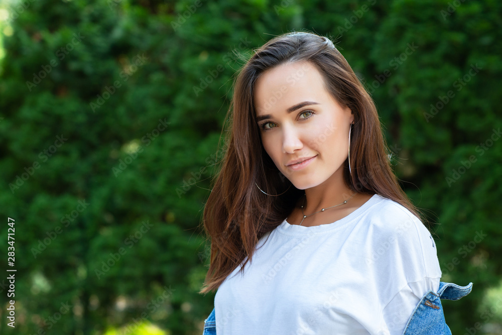 Portrait of beautiful young girl posing in summer park. Majestic woman's beauty. Youth, happiness, lifestyle. Portrait of beautiful young girl posing in summer park. Majestic woman's beauty. Youth, happiness, lifestyle.