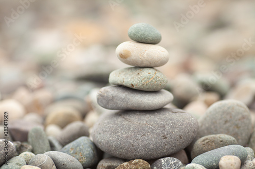  Stones tower with blurred sea background. Pyramid on the center. Zen garden. Spa set.