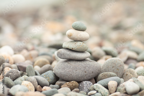  Stones tower with blurred sea background. Pyramid on the center. Zen garden. Spa set.