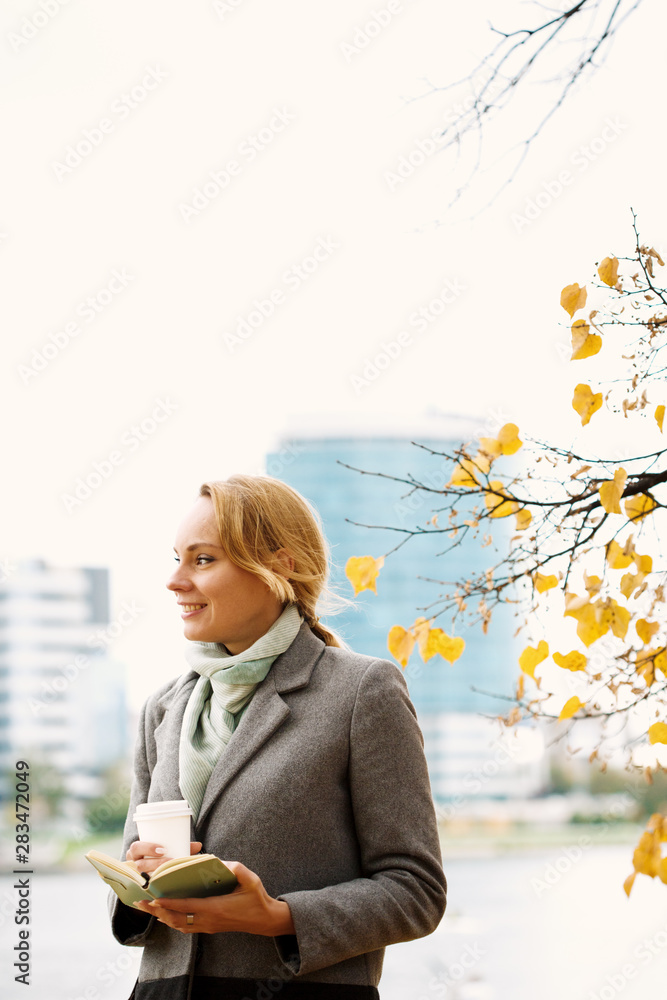 Smart woman walking and drinking take away coffee