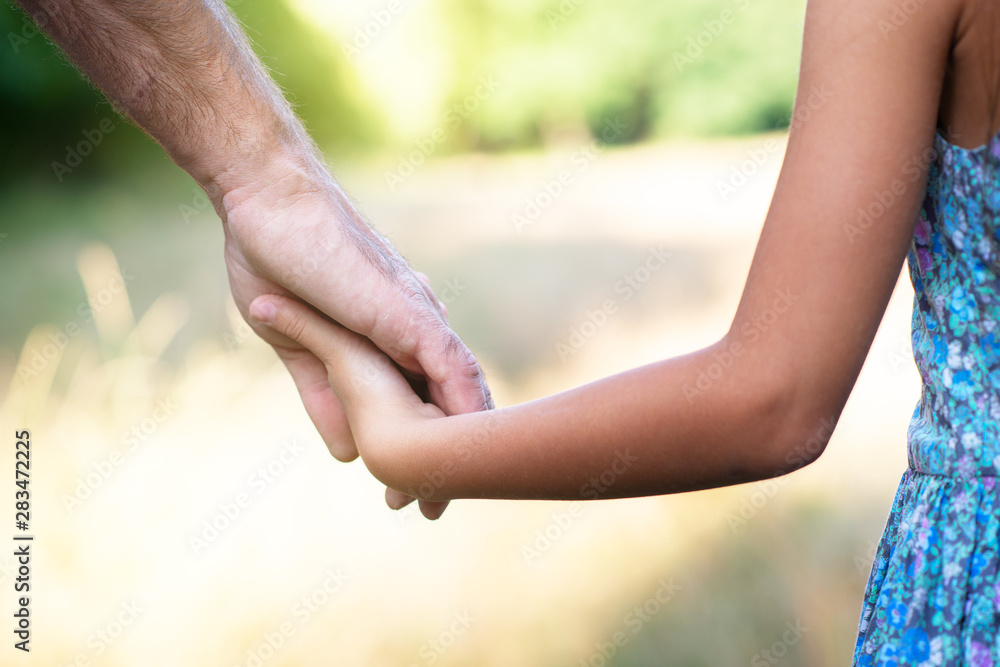 Man's and kid's hands. Father leads his child, summer nature outdoor. Parenting, togetherness, help, union, childhood, trust, family concept. Man's and kid's hands. Father leads his child, summer nature outdoor. Parenting, togetherness, help, union, childhood, trust, family concept.