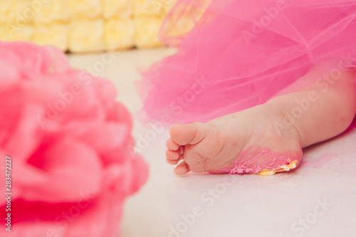 leg of baby food on white background. Feet and cake