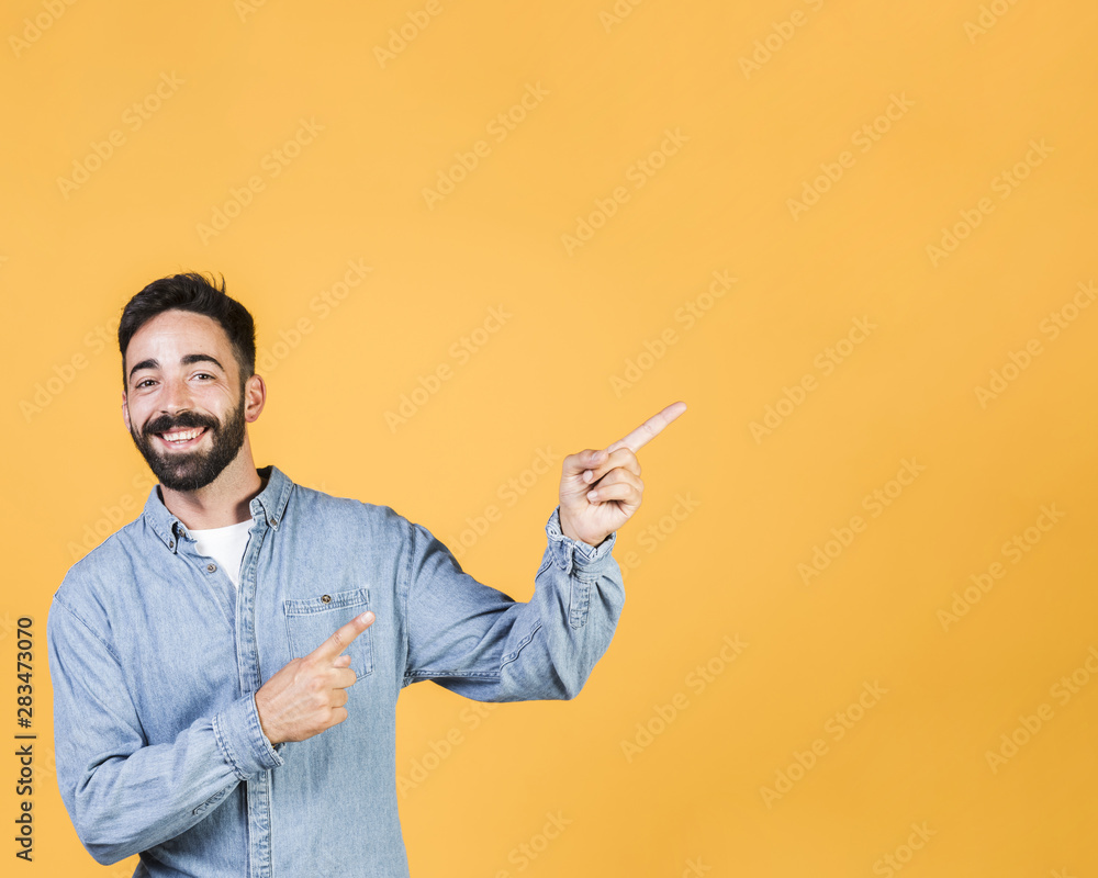 Medium shot smiley guy pointing up Medium shot smiley guy pointing up