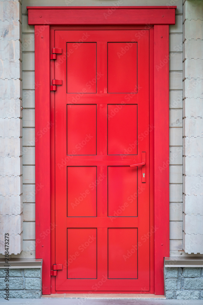 bright red door in a wooden house