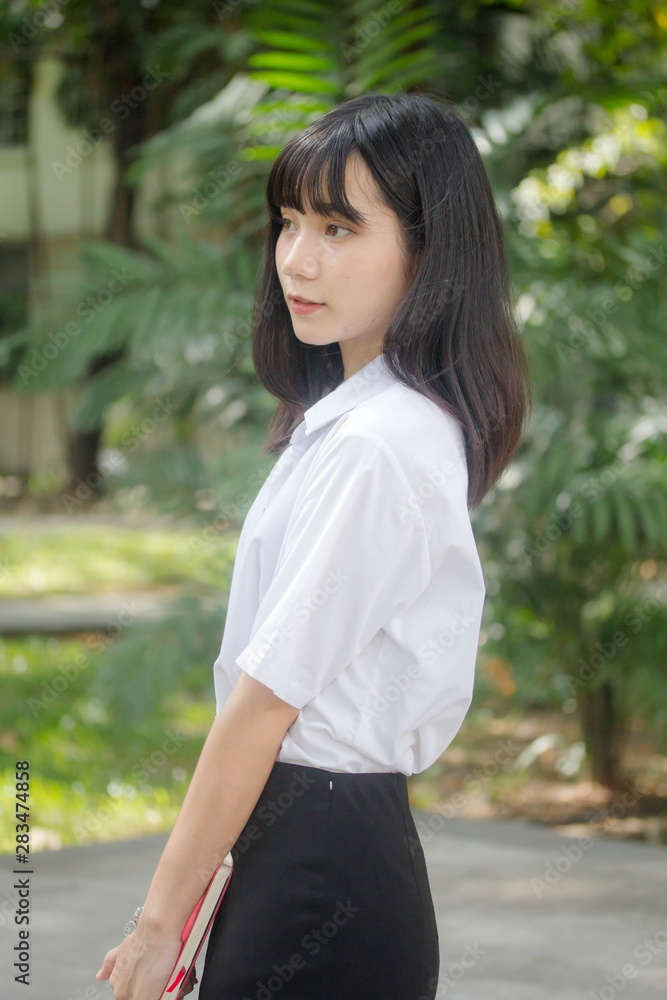 Portrait of thai adult student university uniform beautiful girl relax and smile Portrait of thai adult student university uniform beautiful girl relax and smile