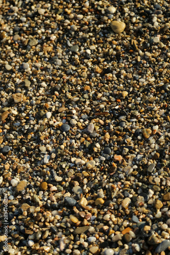 Small sea stones, stones on the beach, vacation at sea, pebbles seashore. Background. Texture.