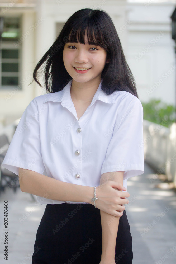 Portrait of thai adult student university uniform beautiful girl relax and smile Portrait of thai adult student university uniform beautiful girl relax and smile