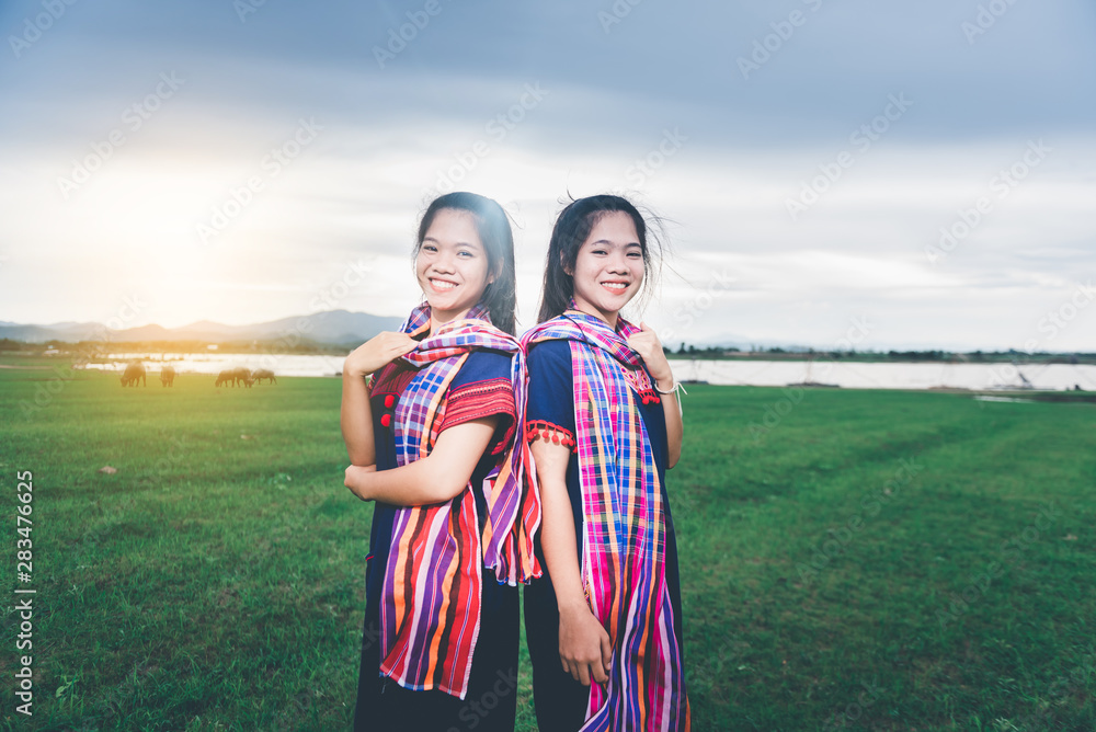 Portrait of beautiful Asian girl with local dress, standing in the mist of fieldt at countryside of Thailand