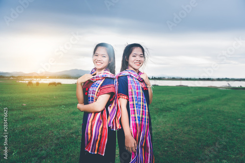 Portrait of beautiful Asian girl with local dress, standing in the mist of fieldt at countryside of Thailand