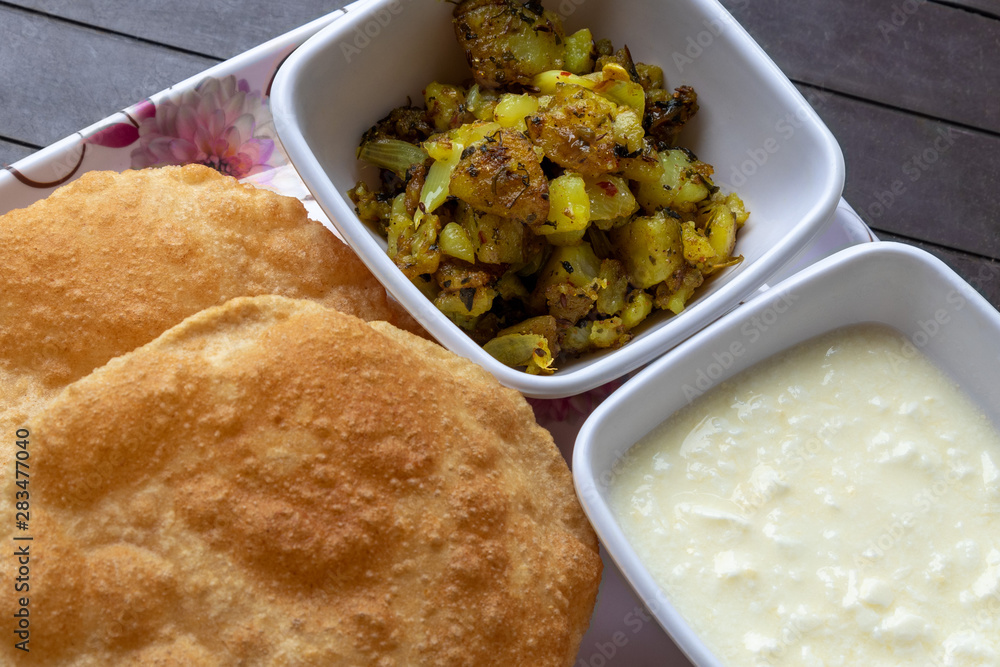 Puri Bhaji, Masala Aloo Sabzi fry served with fried puri or Indian bread and curd. Puri Bhaji, Masala Aloo Sabzi fry served with fried puri or Indian bread and curd.