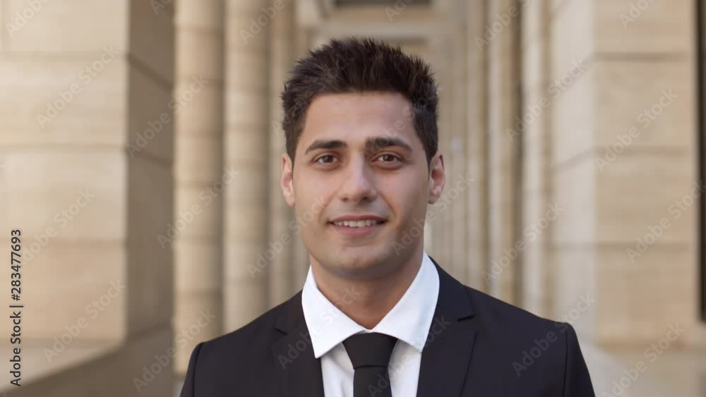 Close up of young mixed-race handsome businessman looking at camera with smile on his face Close up of young mixed-race handsome businessman looking at camera with smile on his face