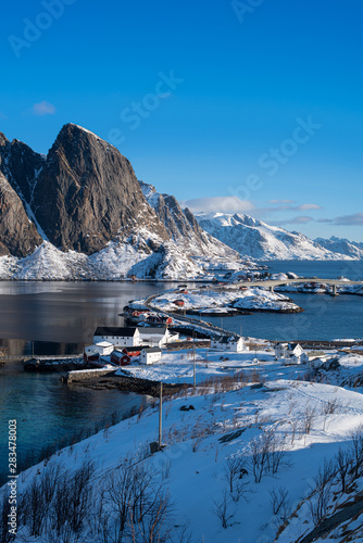 Fishermen’s cabins (rorbu) in the Hamnoy village under blue sky in winter season, Lofoten islands, Norway © surachetkhamsuk