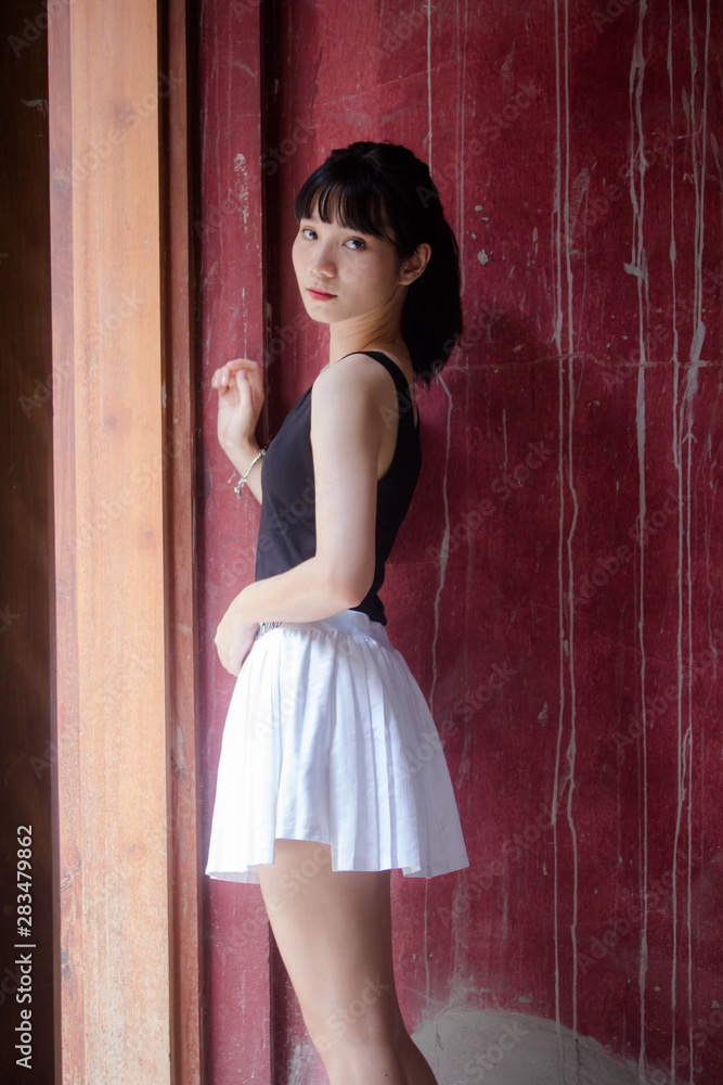 Portrait of thai adult beautiful girl black shirt white skirt relax time Portrait of thai adult beautiful girl black shirt white skirt relax time