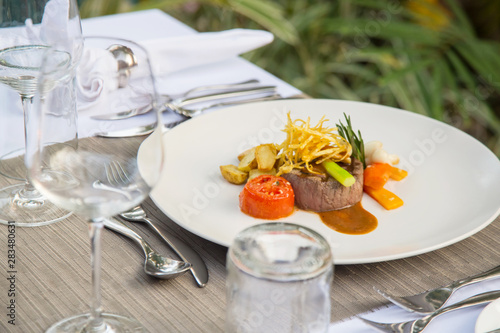 Beefsteak served with steamed vegetables, Exquisite dish, creative restaurant meal concept