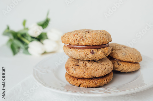 Delicious crumbly sandwich cookies Baci di Dama or Lady kisses with chocolate filling