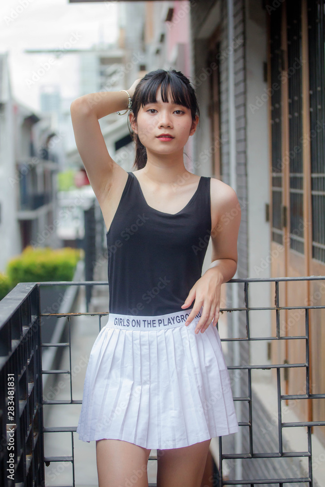 Portrait of thai adult beautiful girl black shirt white skirt relax time Portrait of thai adult beautiful girl black shirt white skirt relax time