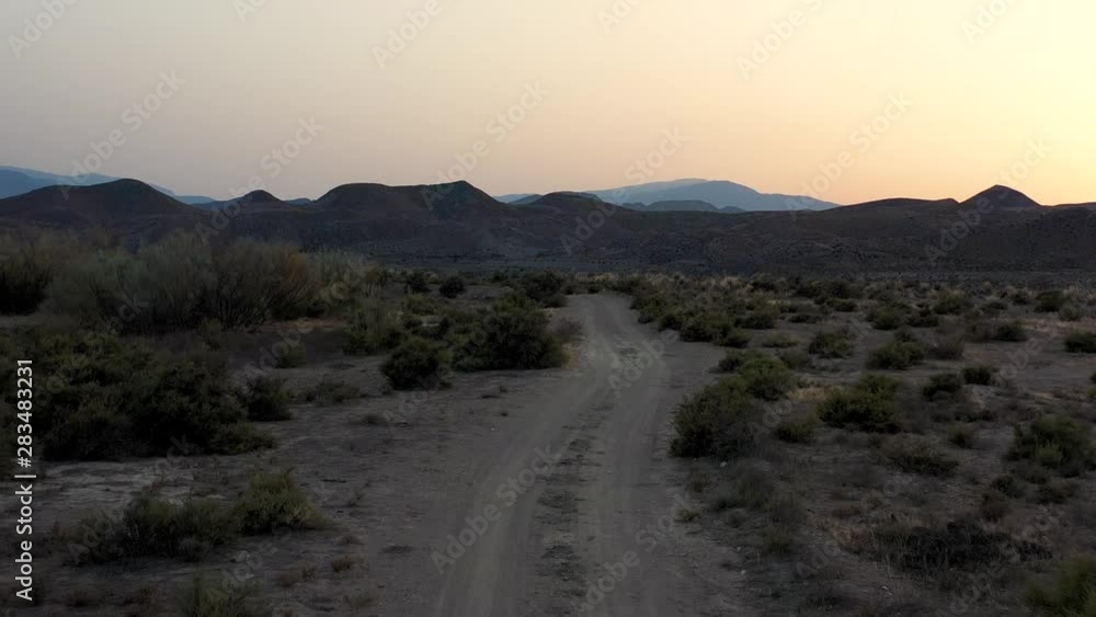 Desert in Tabernas, Almeria, Spain. Low angle following dirt track towards mountains. Desert in Tabernas, Almeria, Spain. Low angle following dirt track towards mountains.