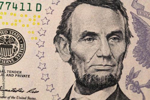 Abraham Linkoln portrait. Five dollars banknote closeup macro.