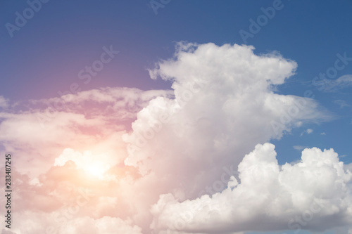 Cloudy in the bright blue sky with the sun light that passes through the clouds