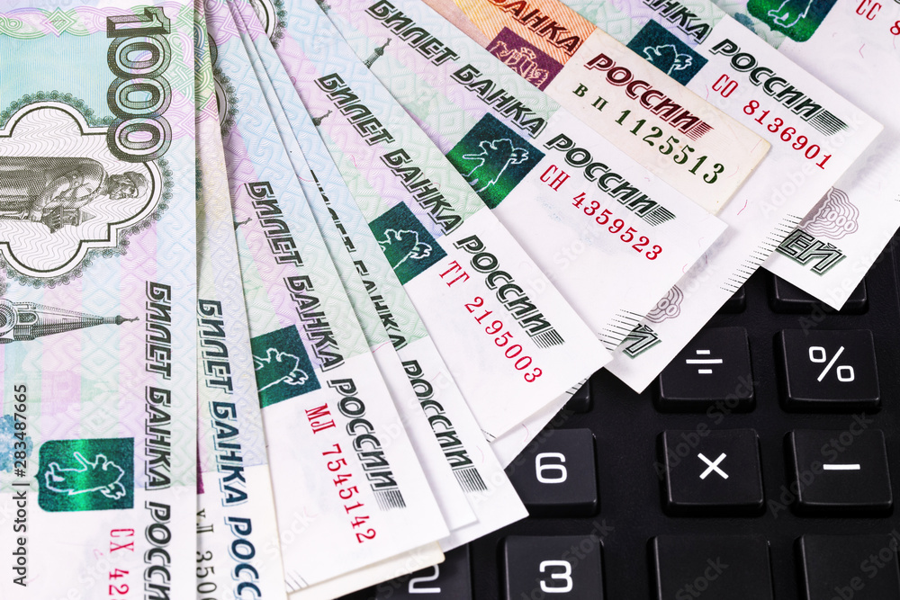 finance concept in closeup calculator on the Russian money, rubles banknotes background finance concept in closeup calculator on the Russian money, rubles banknotes background