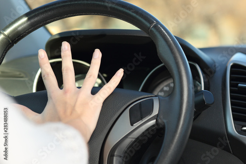 Car driver hand honking horn © Antonioguillem