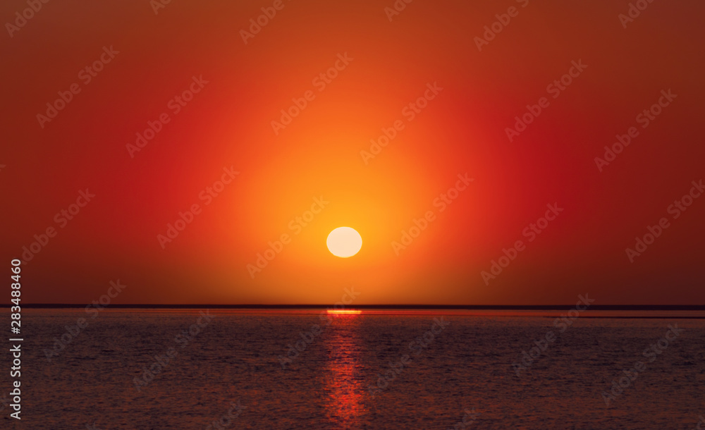 Beautiful  red sunset on the beach and sea