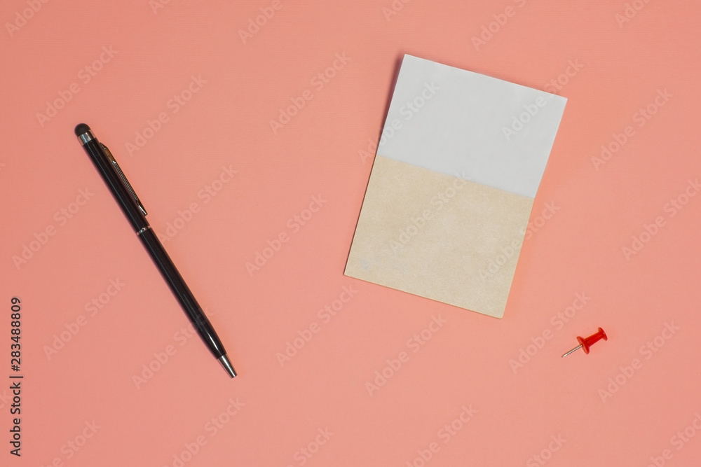 Blank paper sheet with pen on Living Coral Trend top view copy space Blank paper sheet with pen on Living Coral Trend top view copy space