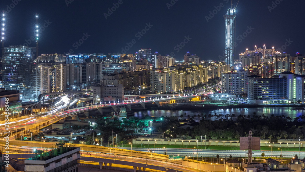 Fototapeta premium Palm Jumeirah Highway bridge aerial night timelapse. Dubai, United Arab Emirates