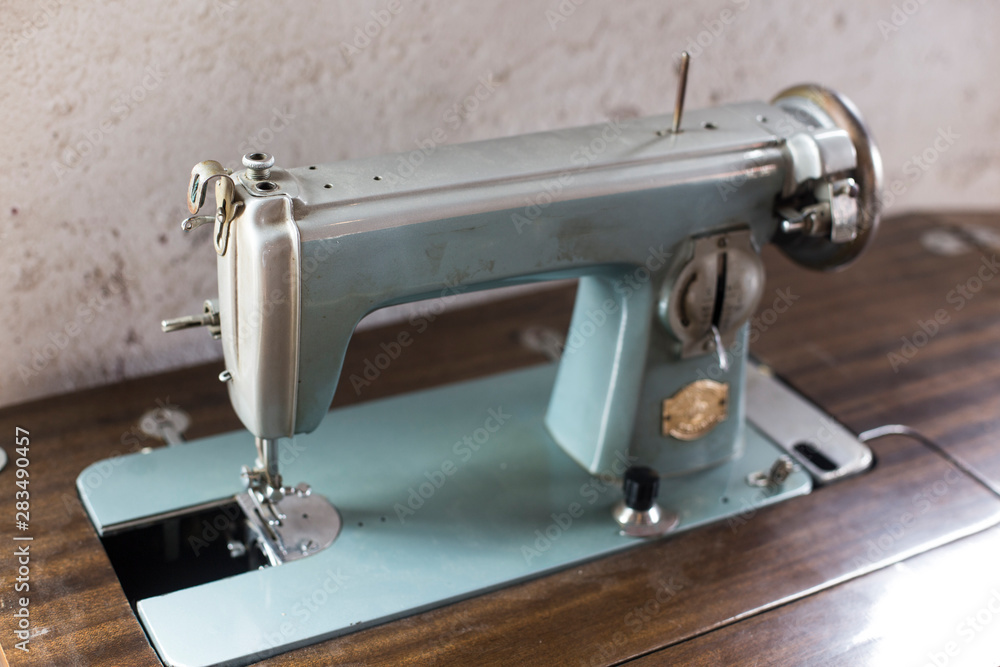 vintage sewing machine isolated on wooden table