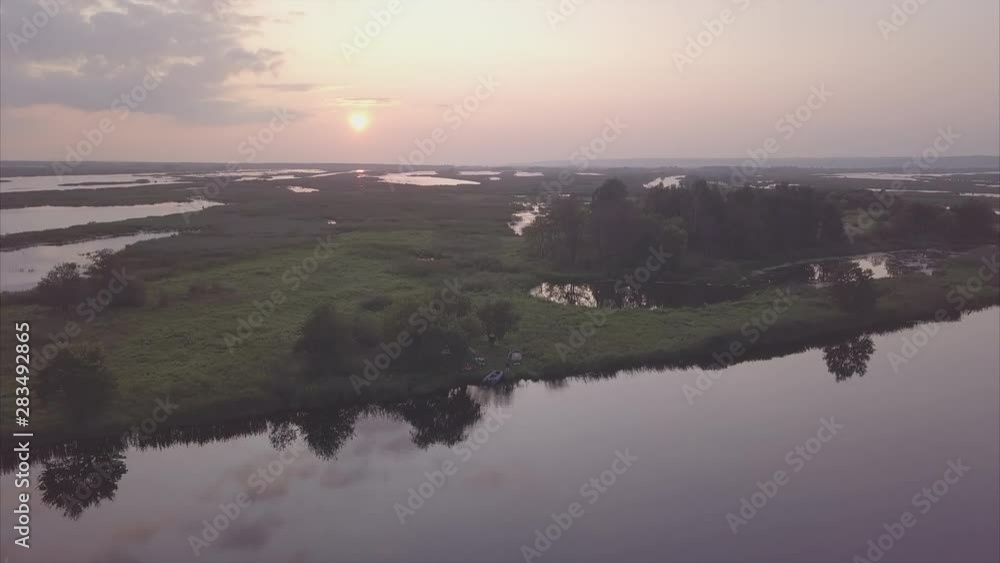 Angler casts the lure on the lake. Then camera ascends and shows the entire fishing area of the lake during the calm summer evening. Clip is non linear in time. No color grading (DJI Mavic Pro, D-Log) Angler casts the lure on the lake. Then camera ascends and shows the entire fishing area of the lake during the calm summer evening. Clip is non linear in time. No color grading (DJI Mavic Pro, D-Log)