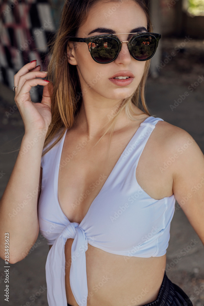 Portrait of stylish blonde woman outdoor wearing sunglasses Portrait of stylish blonde woman outdoor wearing sunglasses