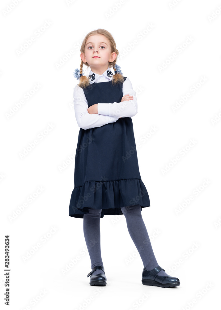 Little confident girl schoolgirl in uniform isolated on white background Little confident girl schoolgirl in uniform isolated on white background