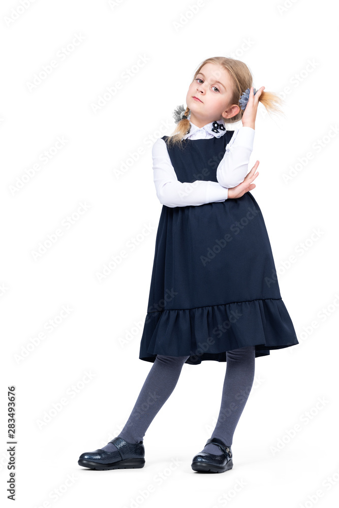 Little confident girl schoolgirl in uniform isolated on white background Little confident girl schoolgirl in uniform isolated on white background