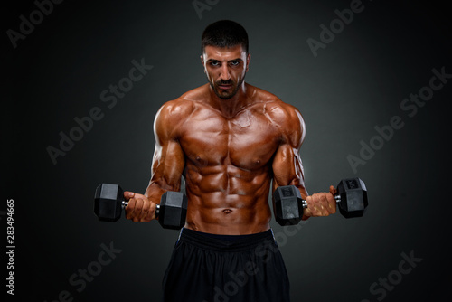 Strong Muscular Men Lifting Weights © mrbigphoto