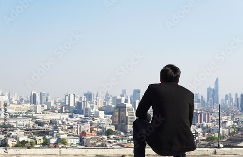 Businessman looking city to the future on rooftop