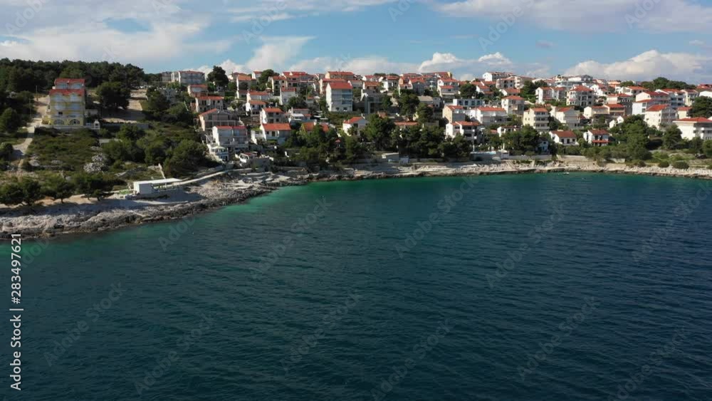 Flying along a typical Mediterranean village by the coast in Dalmatia province, Croatia. Flying along a typical Mediterranean village by the coast in Dalmatia province, Croatia.