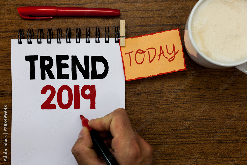 Text sign showing Trend 2019. Conceptual photo things that is famous for short period of time in current year Man holding marker notebook clothespin reminder wooden table cup coffee Text sign showing Trend 2019. Conceptual photo things that is famous for short period of time in current year Man holding marker notebook clothespin reminder wooden table cup coffee