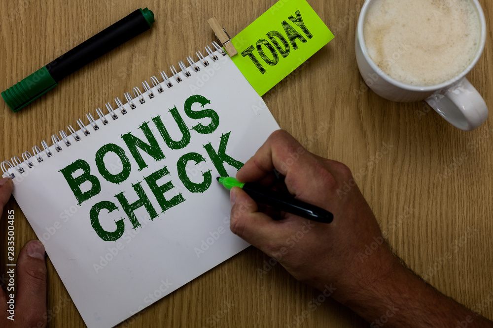 Conceptual hand writing showing Bonus Check. Business photo showcasing something in addition to what is expected or strictly due Man holding marker notebook reminder wooden table cup coffee Conceptual hand writing showing Bonus Check. Business photo showcasing something in addition to what is expected or strictly due Man holding marker notebook reminder wooden table cup coffee