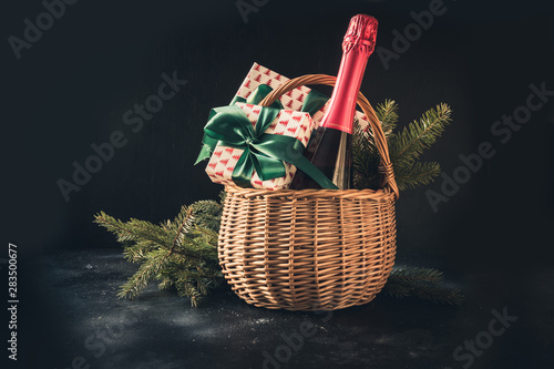 Photography Christmas gift hamper with champagne and gift on black