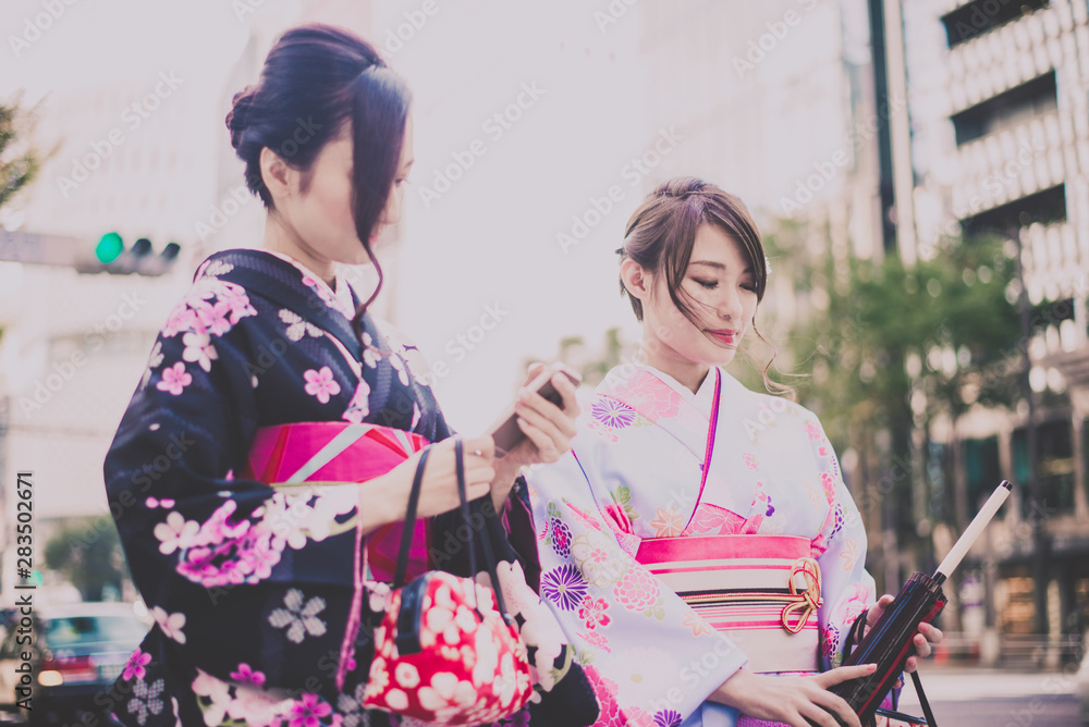Two japanese girls wearing kimonos traditional clothes, lifestyle moments Two japanese girls wearing kimonos traditional clothes, lifestyle moments