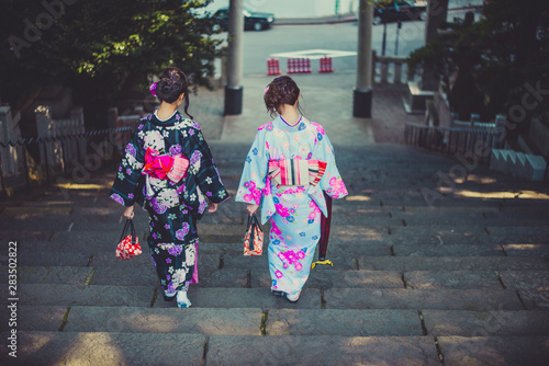 Two japanese girls wearing kimonos traditional clothes, lifestyle moments