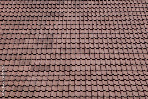 Brown roof with metal tile on blue sky